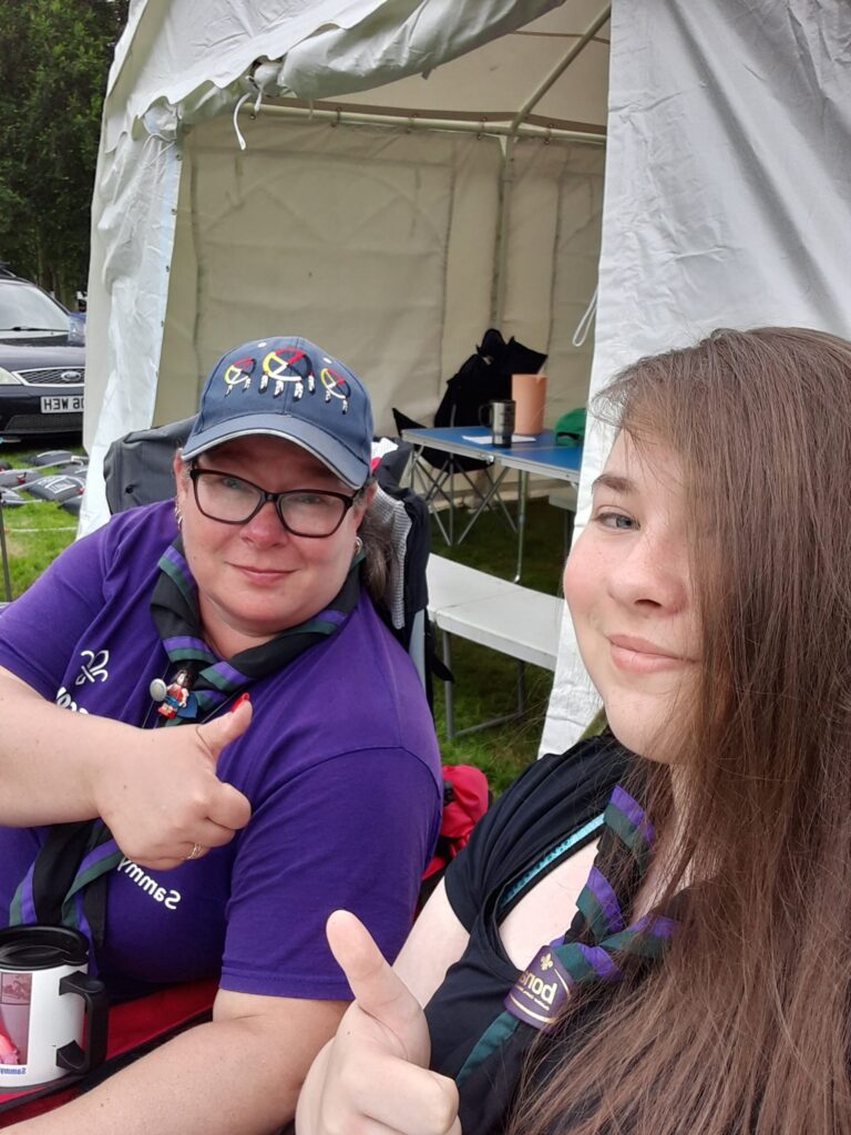 Two members of the Scout group sitting together at camp.