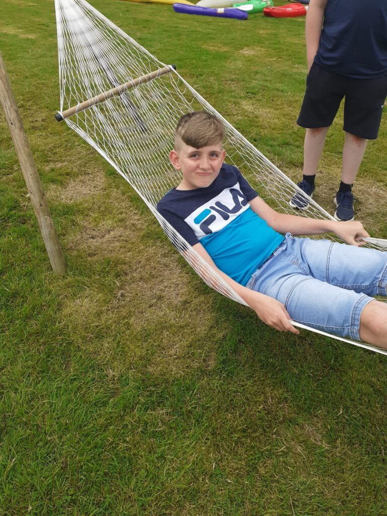 Scout resting in a hammock at camp.