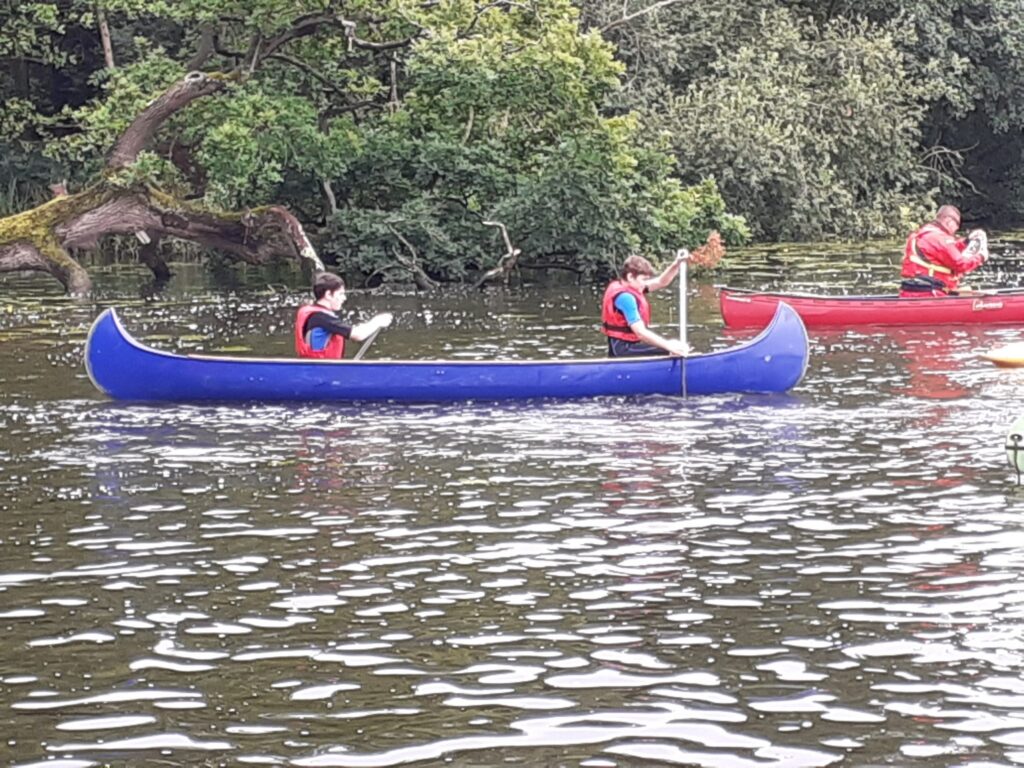 Two paddlers sharing a canoe on the water.