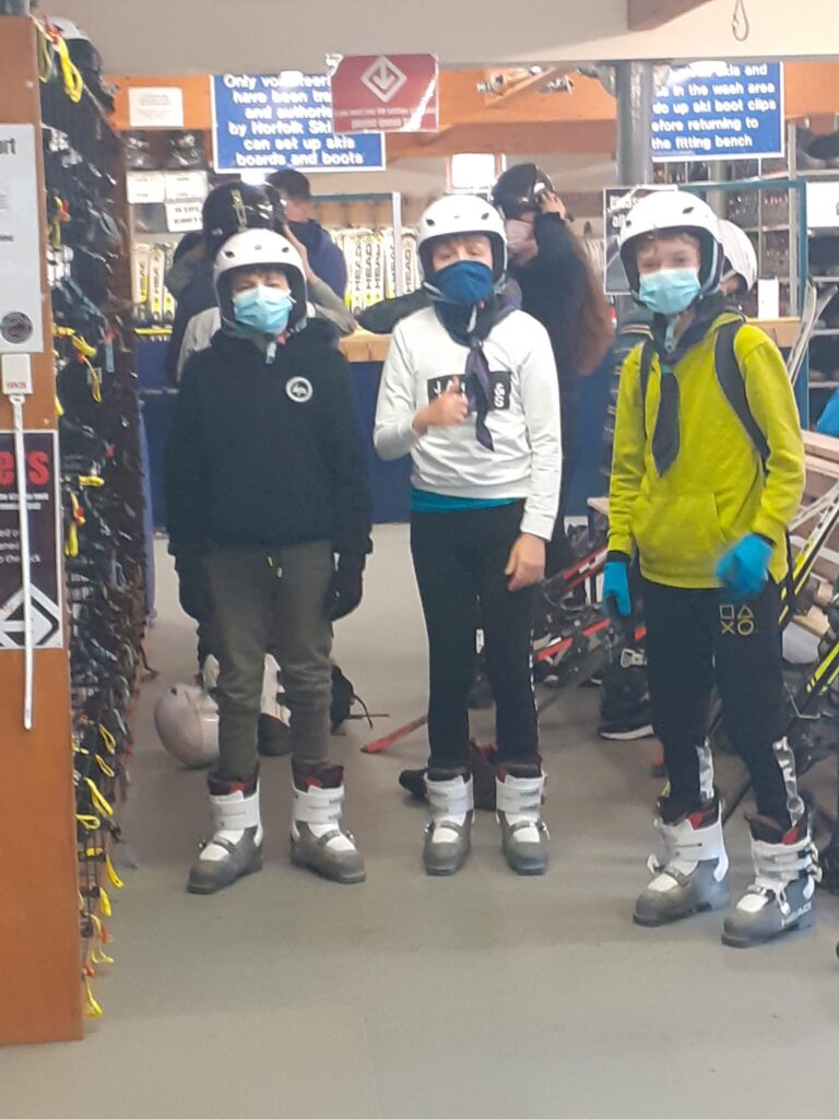 Group wearing helmets and ski equipment for a skiing activity.
