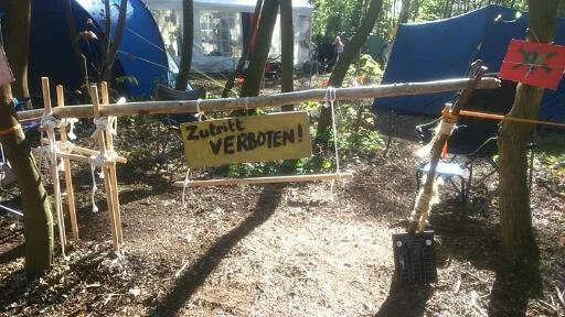 Scout campsite entrance built with wooden poles and rope.