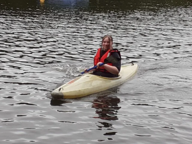 Paddler wearing a buoyancy aid in a kayak.